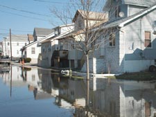 Flooded street in front of a house