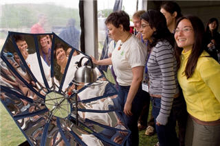 students standing in front of their award-winning three-in-one solar cooker, heater and electricity generator