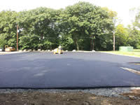 The parking lot after 2 layers of pavement have been poured, spread and rolled. 