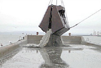 Dredge emptying out onto barge.