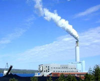 Photo showing a factory releasing smoke/steam into the air.