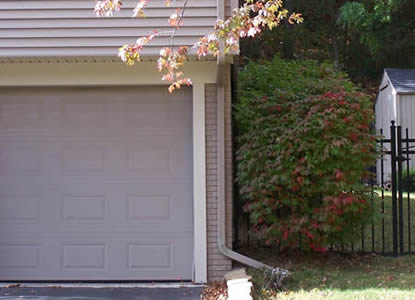 Downspout directs rain to landscaped area