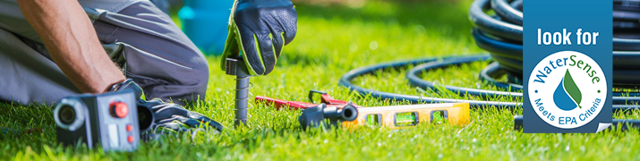 Man adjusting irrigation system.