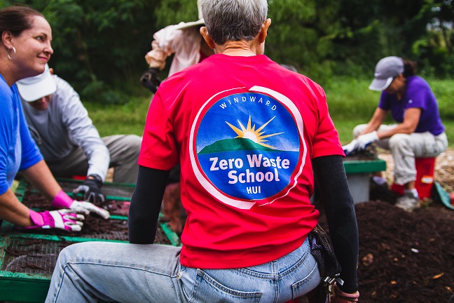 Photo of the back of a man in Windward School t-shirt