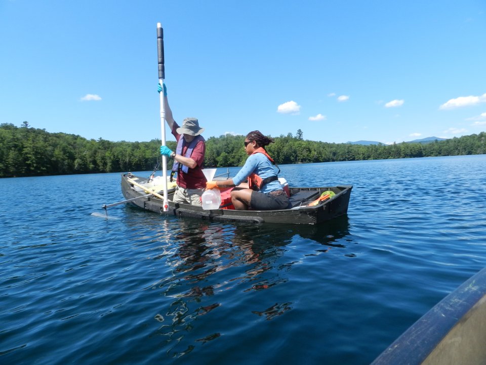 Field crew members use an integrated sampler to draw water for filtration and analysis.