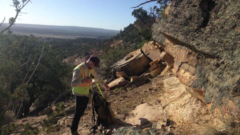 EPA Contractor in yellow vest with handheld device and backpack