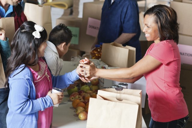 little girl and woman at food donation drive