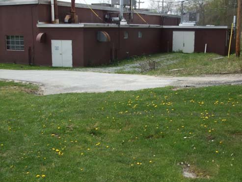 Manufacturing building and concrete pad area on the site