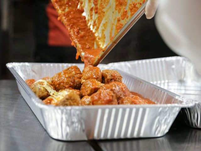 food being poured into an aluminum pan