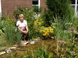 Ms. Learning sits ina beautiful garden