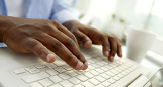 Hands typing on a keyboard