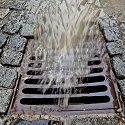 Stormwater runoff flowing into stormdrain