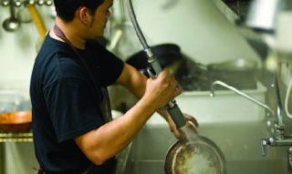 Person using a pre-rinse spray valve