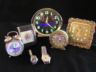 watches and analog clocks with glowing numbers