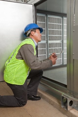 Technician examining HVAC system