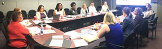 An image of people seated at a conference table for a meeting. A link to https://www.epa.gov/community-port-collaboration