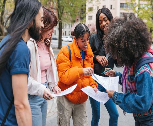 group of people handing out flyers to one another