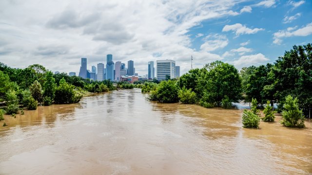 Picture of river flooding with a city's downtown in the background