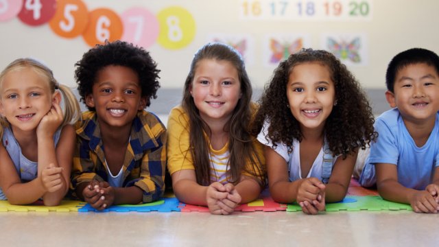 Children laying down in a group.