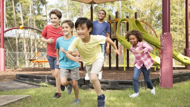 Children running together in the grass