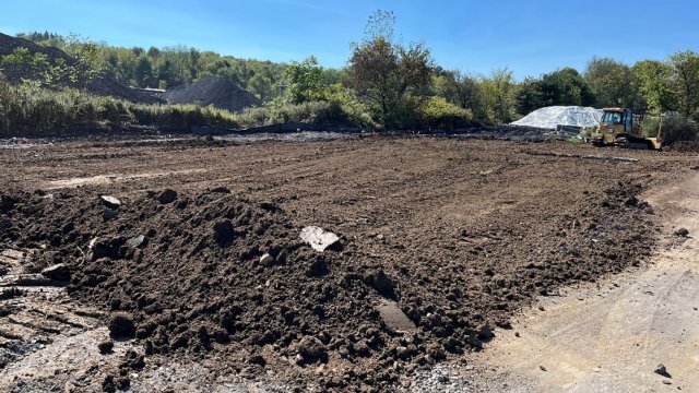 Land ready for grading, with piles of dirt that are being smoothed over.