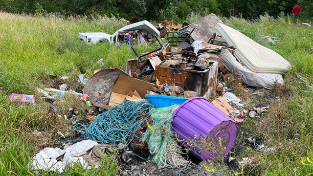 field with trash dumped in it