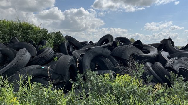 pile of tires in a field