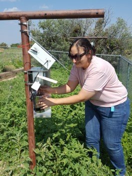 Ingrid George installing canister on ROCS unit in Guadalupe Mountains National Park