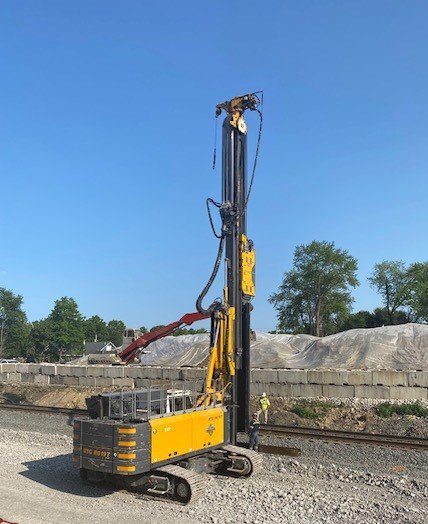 Sheet piling is installed along the tracks