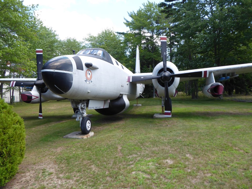 An airplane sitting in a grassy clearing.