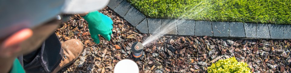 contractor checking spray sprinkler head