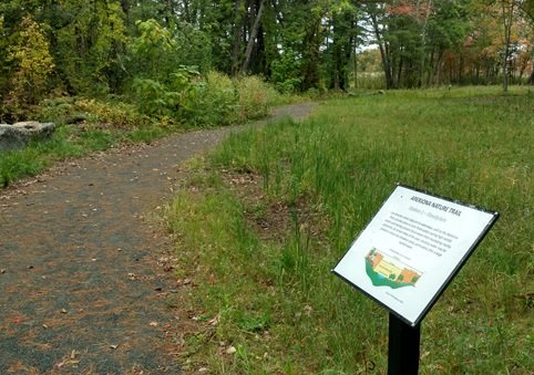 a sign on a nature trail