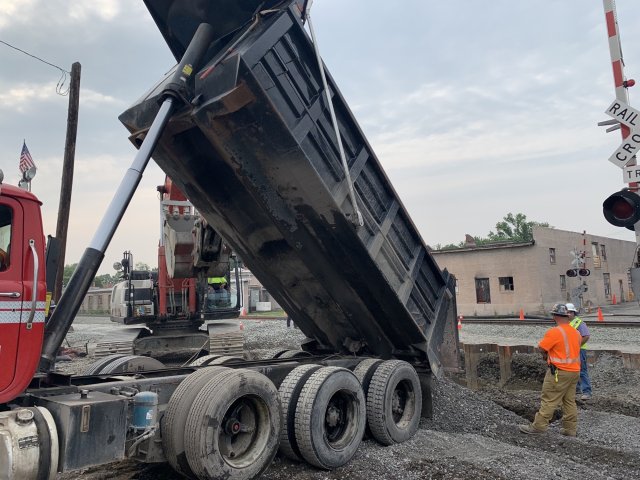 Large truck backfilling the excavated area underneath Pleasant Drive