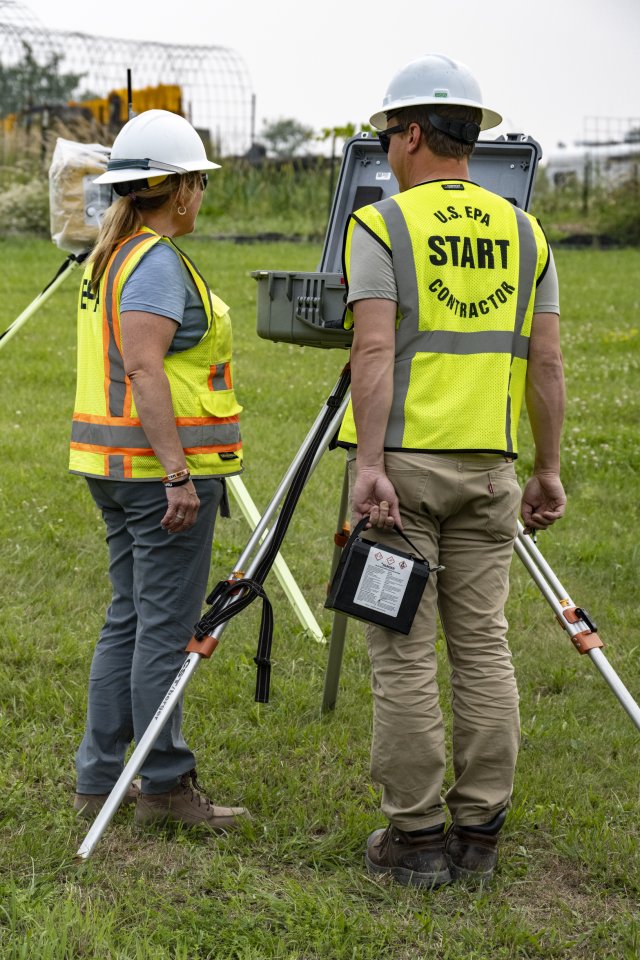 Two people looking at the DustTrack Monitors