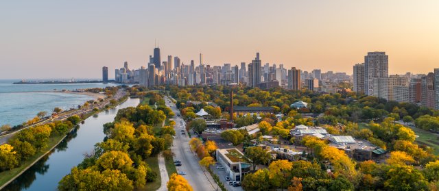 Aerial view of green parks and waterfront leading up to downtown Chicago in the background