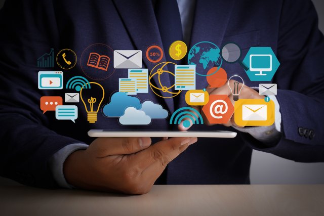 man in a suit holding a table with icons floating above it