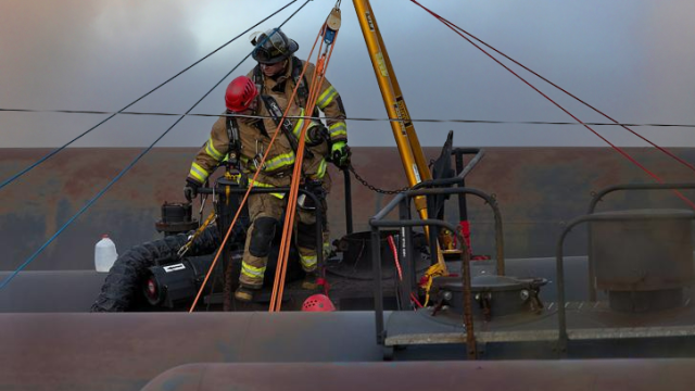 rescue workers on railcar tank