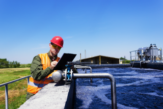 A worker checking a water utility facility.