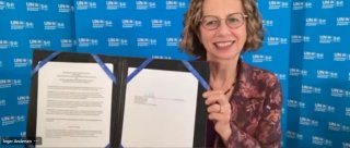 U.N. Environmental Programme Executive Director Inger Andersen holds up a copy of the signed Memorandum of Understanding with U.S. EPA, September 8, 2021