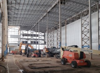 Interior of Segment Three building showing soil in four-inch terraces with cardboard covered pathways for workers and equipment.