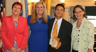 Figure 3 City Market's General Manager John Tashiro receivin g the EPA's 2018 Environmental Merit Award on behalf of the Onion River Co-op