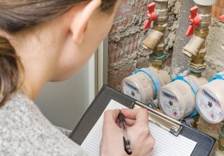 Person reading water meter.