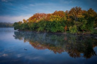 lakefront with fall season forest on the outline 