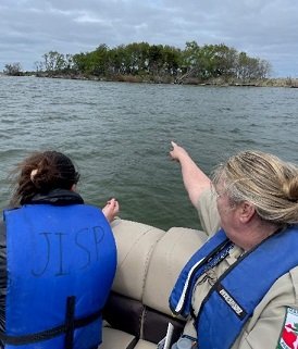 Researchers viewing the marshes of Janes Island State Park by boat.