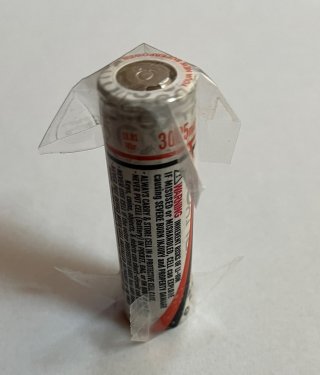 18650 battery with tape on both ends to prevent fires while in storage.