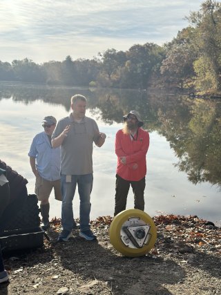 Three people in front of Mashapaug Pond.