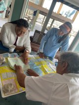 Three people looking at a map.