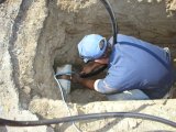 Man fixing underground pipe.